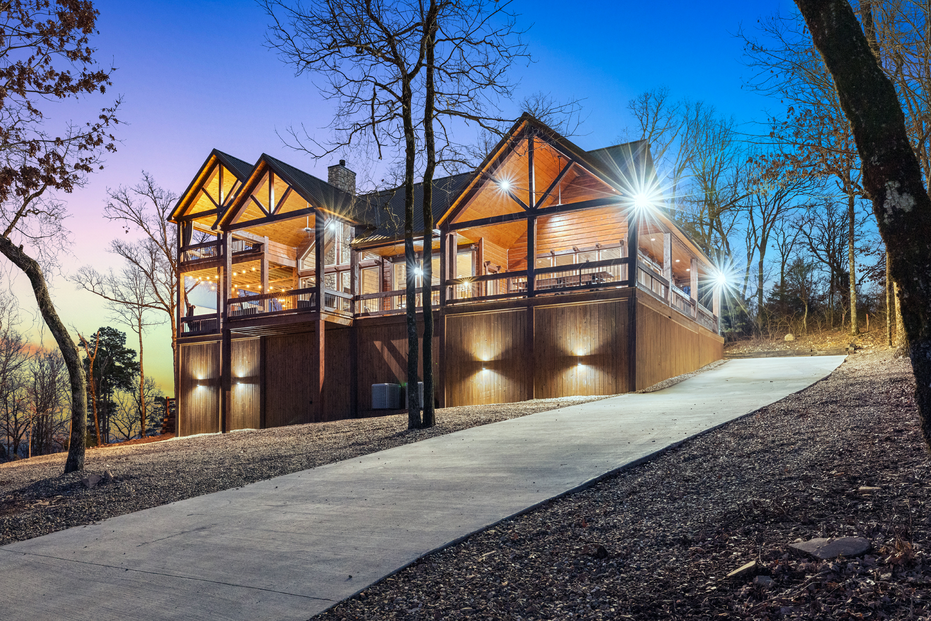 Beautiful nighttime exterior with illuminated architecture and mountain retreat vibes