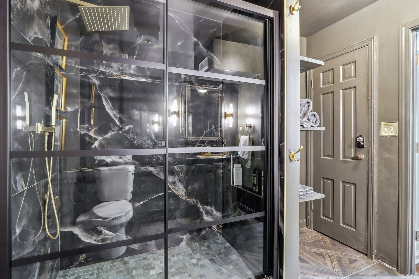 Freshen up in full bathroom 1, featuring a marble-look walk-in shower with a rainfall showerhead.