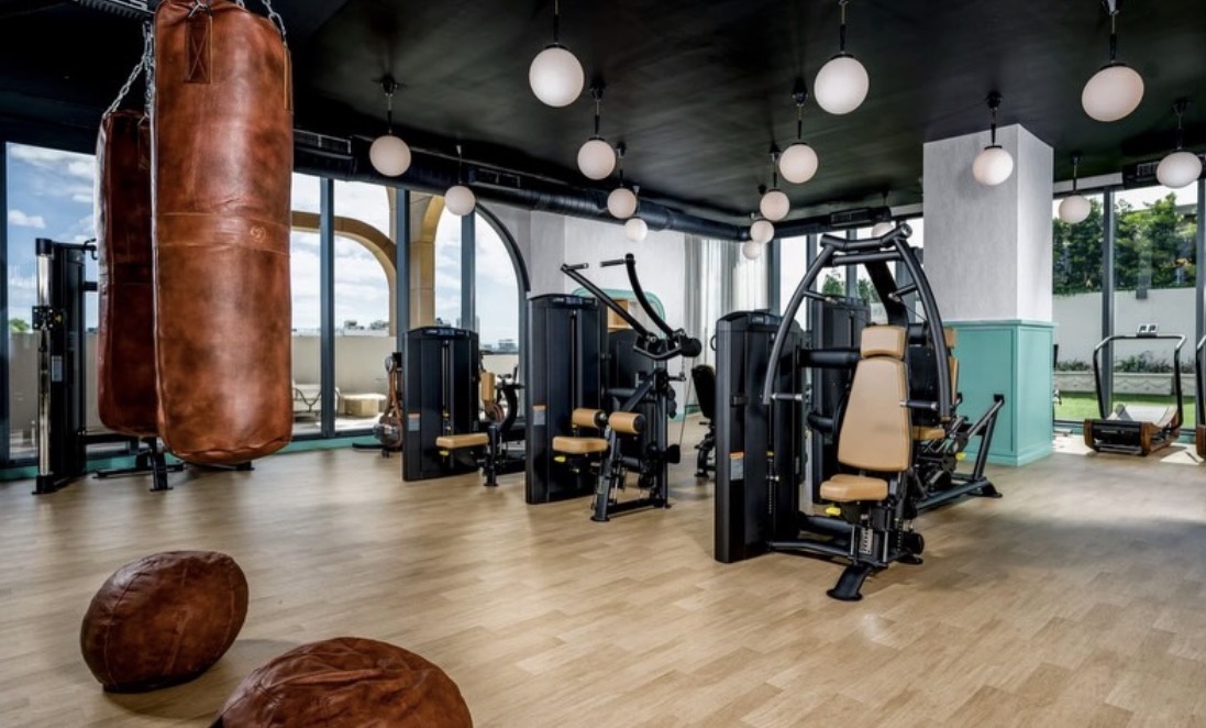 Fitness center with boxing area, weight machines & punching bag — open 24/7
