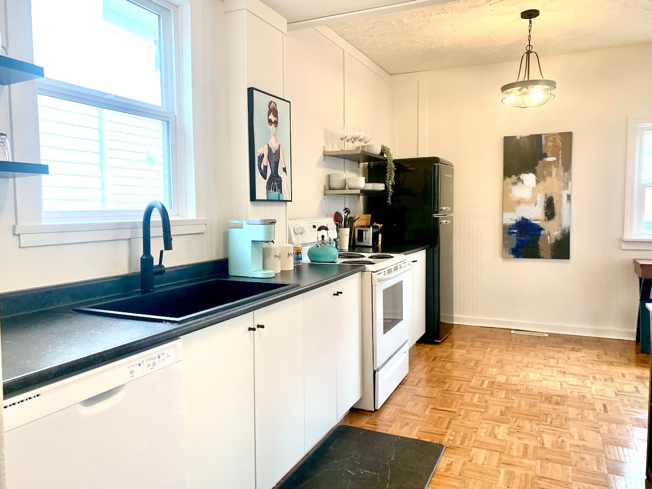 Fully equipped kitchen with stove, microwave, coffee maker, cookware, and dining essentials.