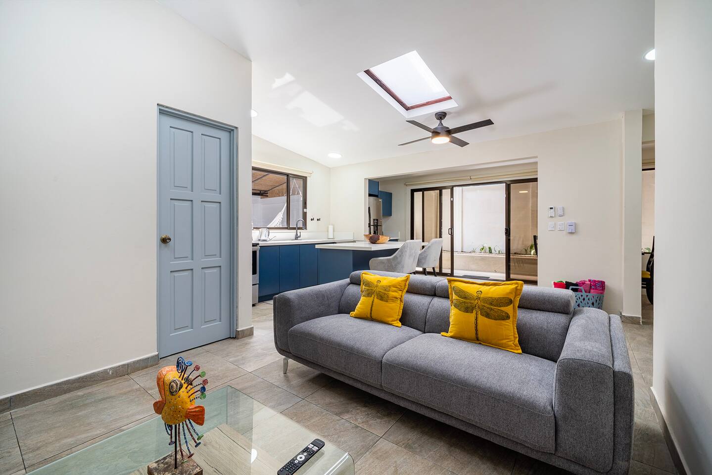 Spacious and cosy living room with couch, bean chairs, TV and chairs