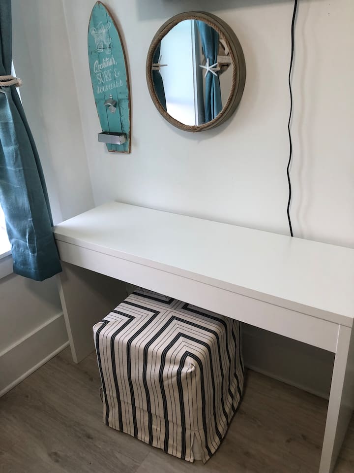 The ultimate flexible space!  This cozy bunk room features two Queen beds and a dedicated workspace with a desk and Smart TV. Perfect for remote work, gaming, or a quiet kid’s retreat—combining 30A comfort with functional utility.