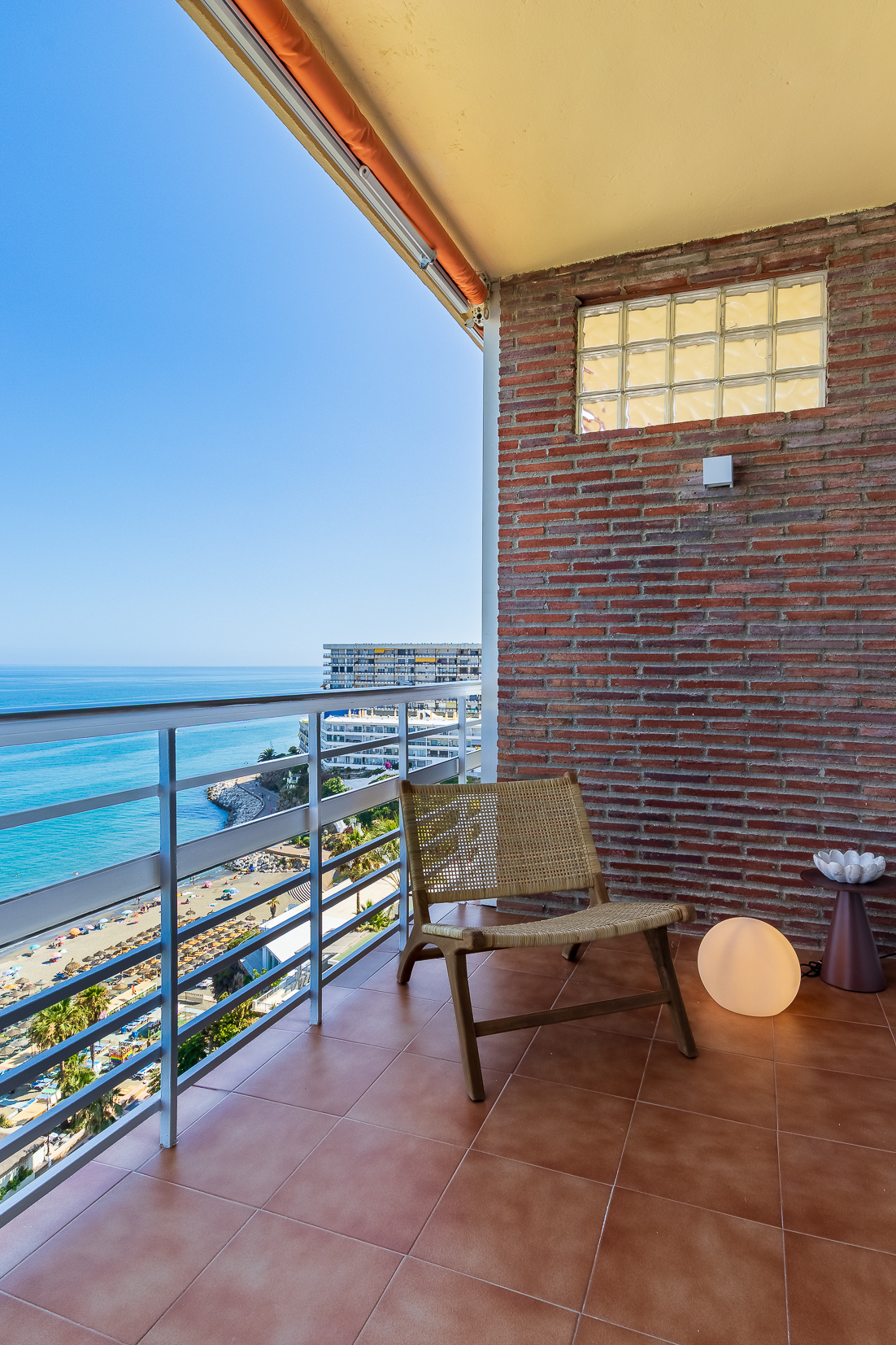 A quiet balcony corner overlooking the beach and sea.