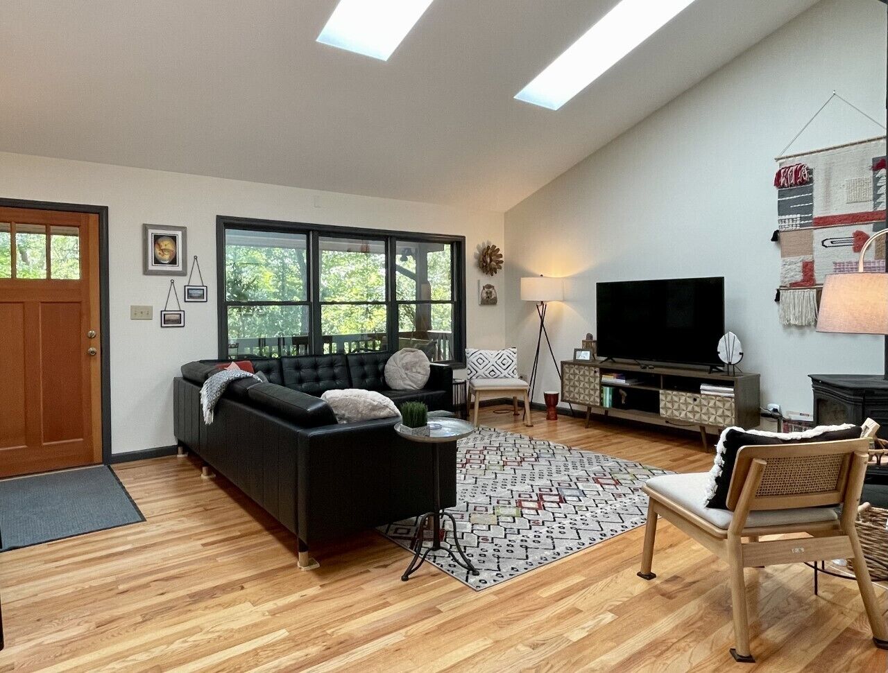 Large living area with smart tv, woodstove, and creature comforts