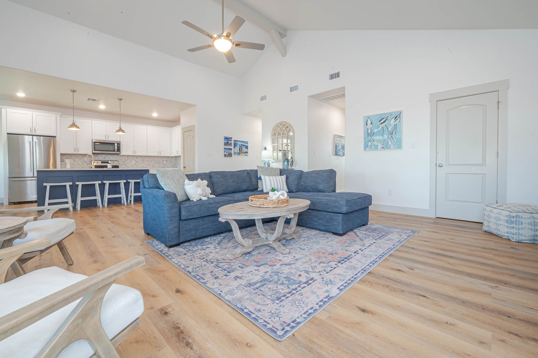 Bright open-concept living area with comfy seating and sleeper sofa — perfect for relaxing after a day on the water