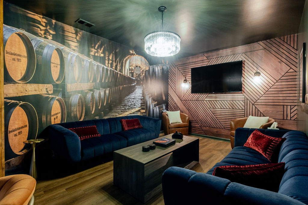 The Rick Row 7 lounge designed with layers of comfort in bourbon tones and plush seating — a speakeasy haven where every sip feels like a story and every conversation lingers a little longer.