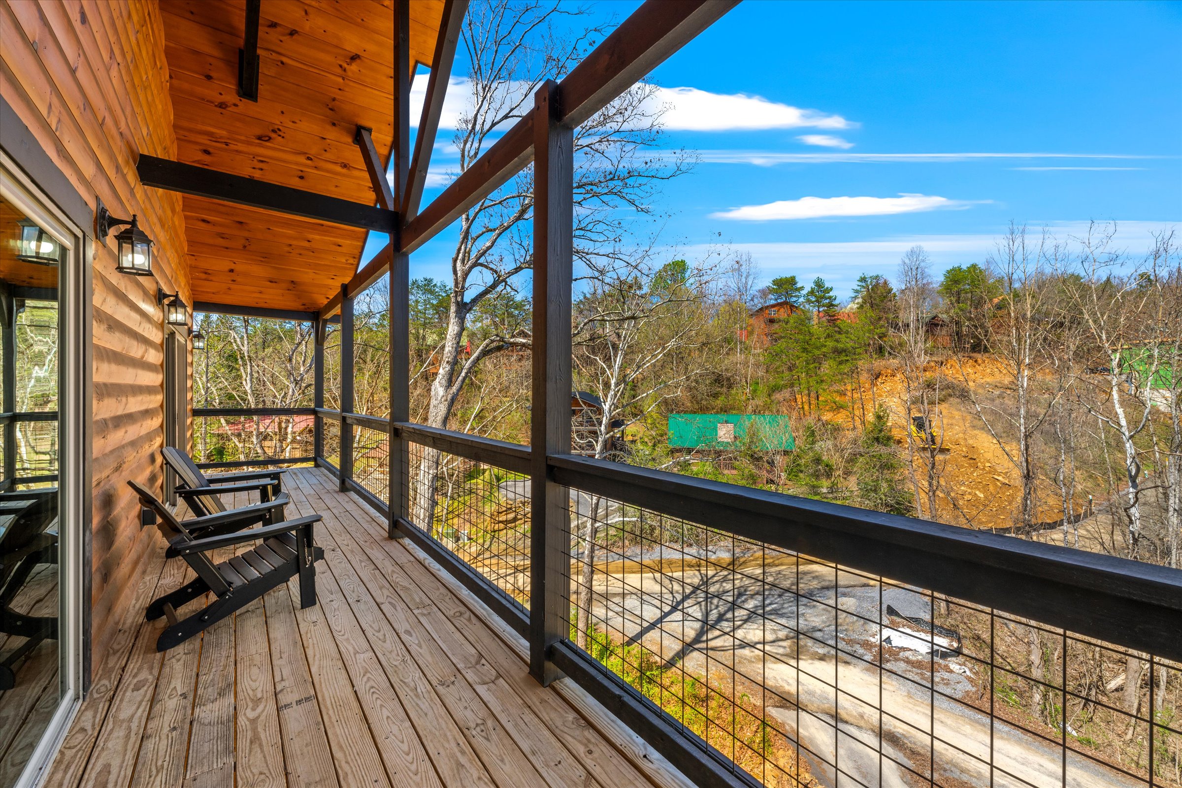 The bedroom opens to a private balcony featuring cozy lounge chairs.