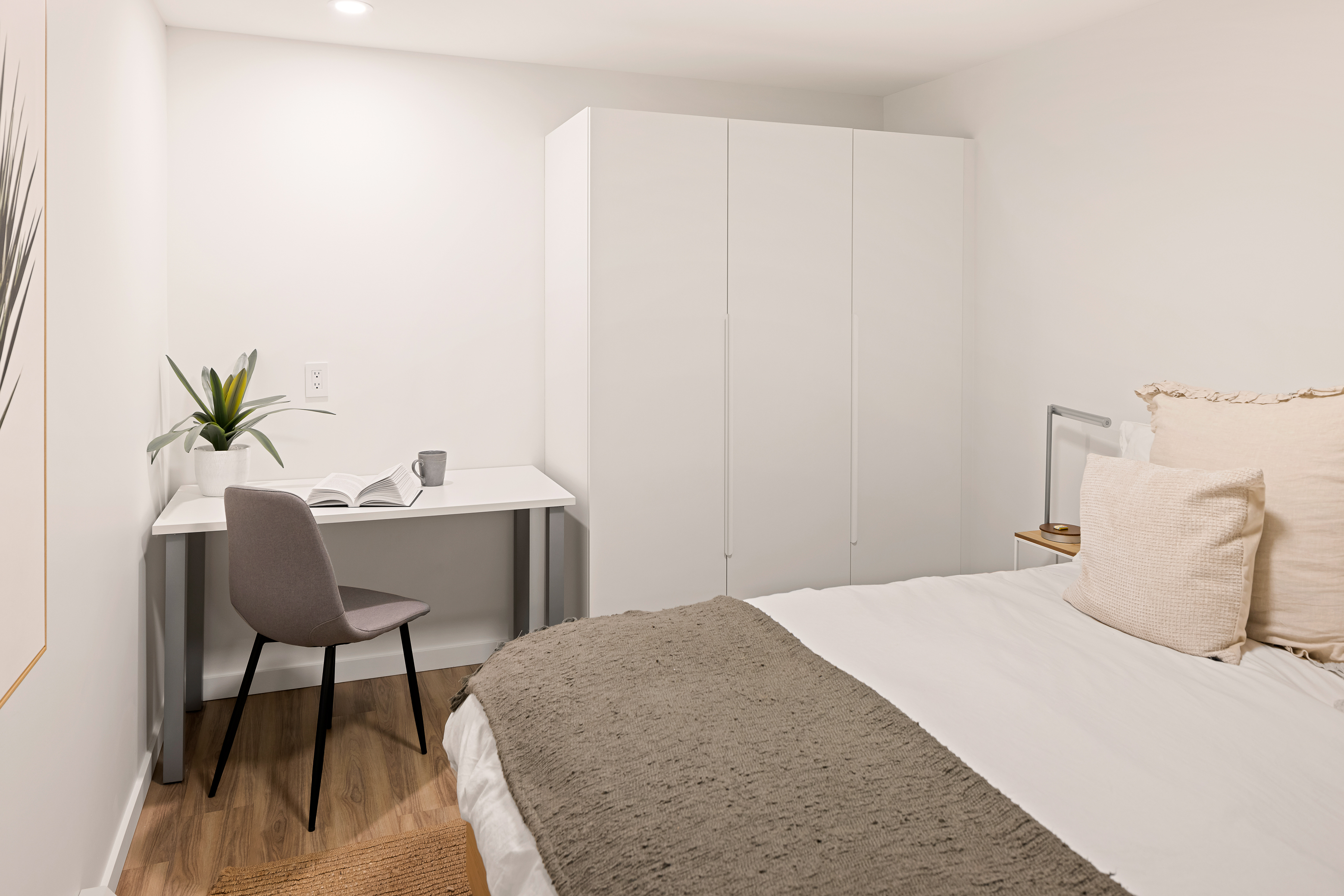 Primary bedroom workspace with desk and wardrobe storage — ideal for focused work or longer stays.