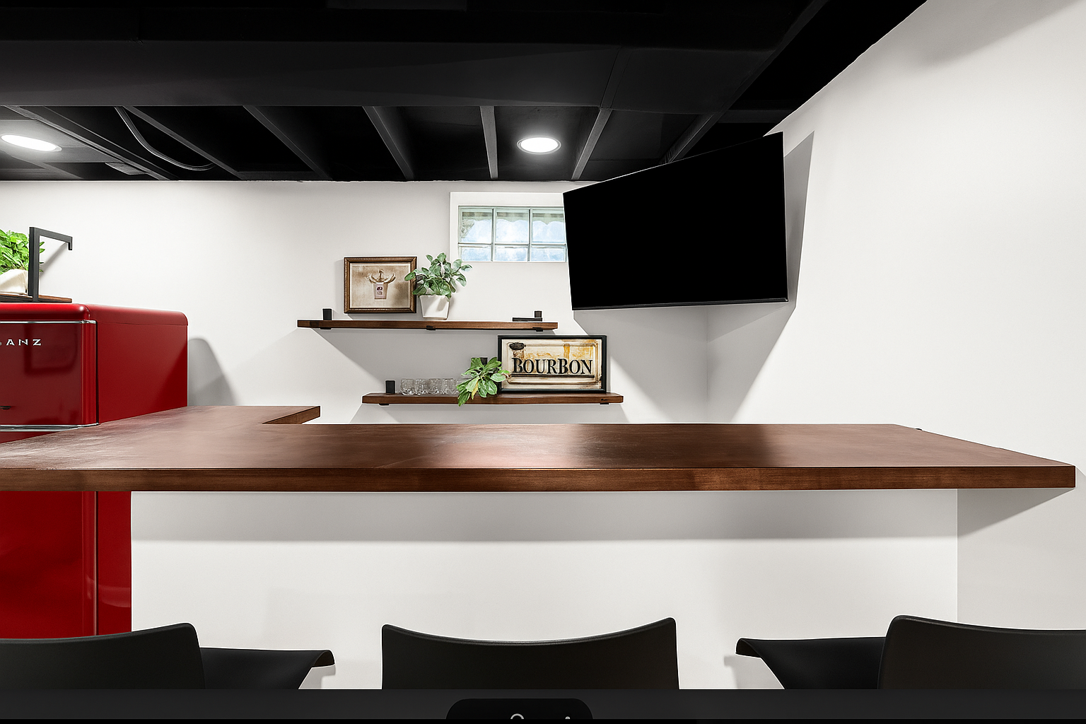 Enjoy your favorite shows or a drink from the bar—Smart TV and stylish shelving complete this basement retreat.