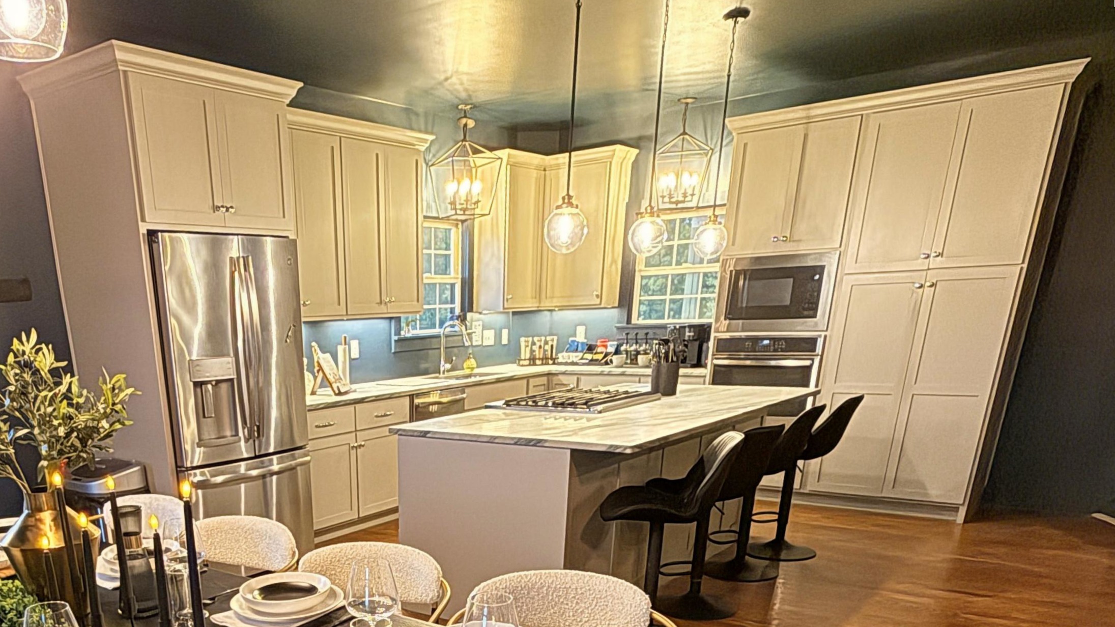 A chef-inspired kitchen designed for connection — with stone countertops, artisan lighting, and premium appliances ideal for tastings, chef dinners, and effortless entertaining.