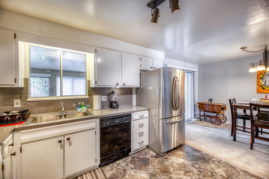 Large refrigerator, dishwasher, glass top stove, huge microwave in this kitchen.