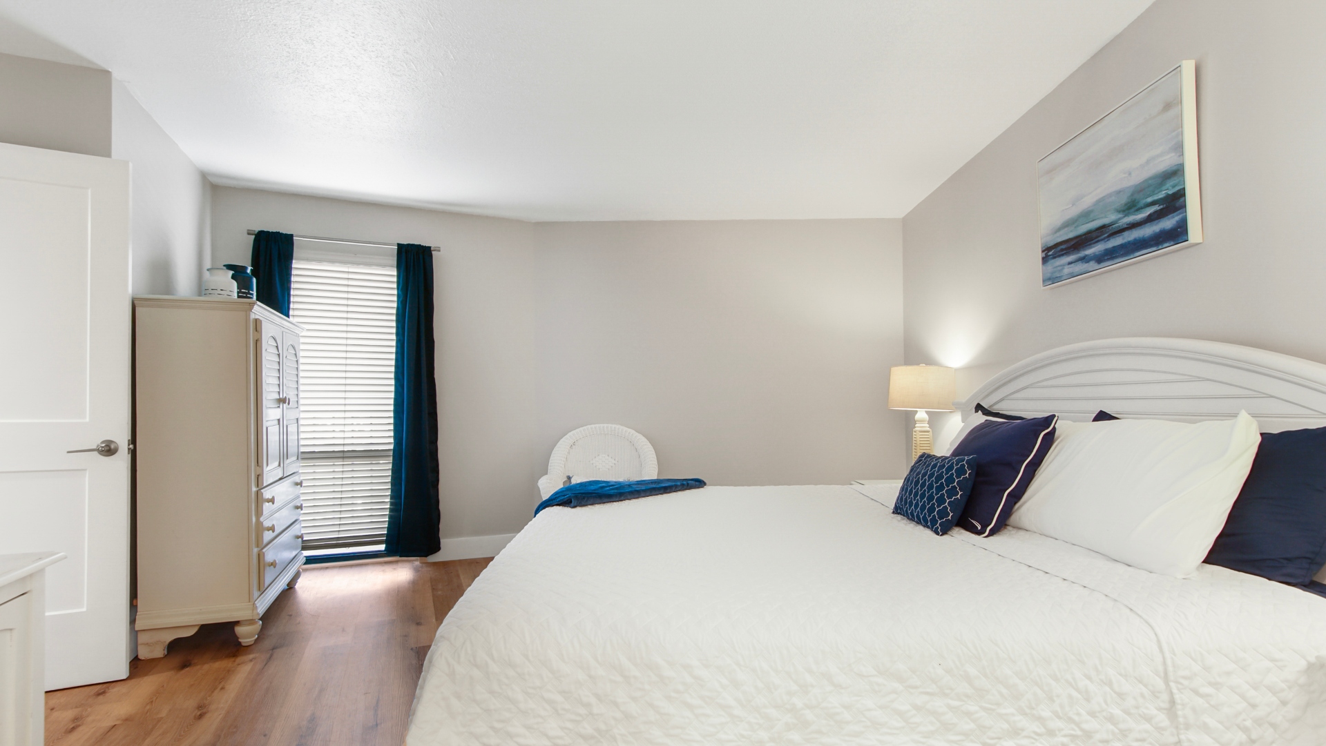 Main bedroom with king bed, ensuite bathroom, smart TV and clothing storage