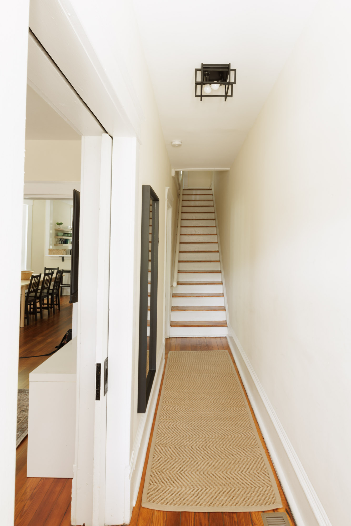 Entrance hallways leads into the living room, dining area, and stairs to the second floor.