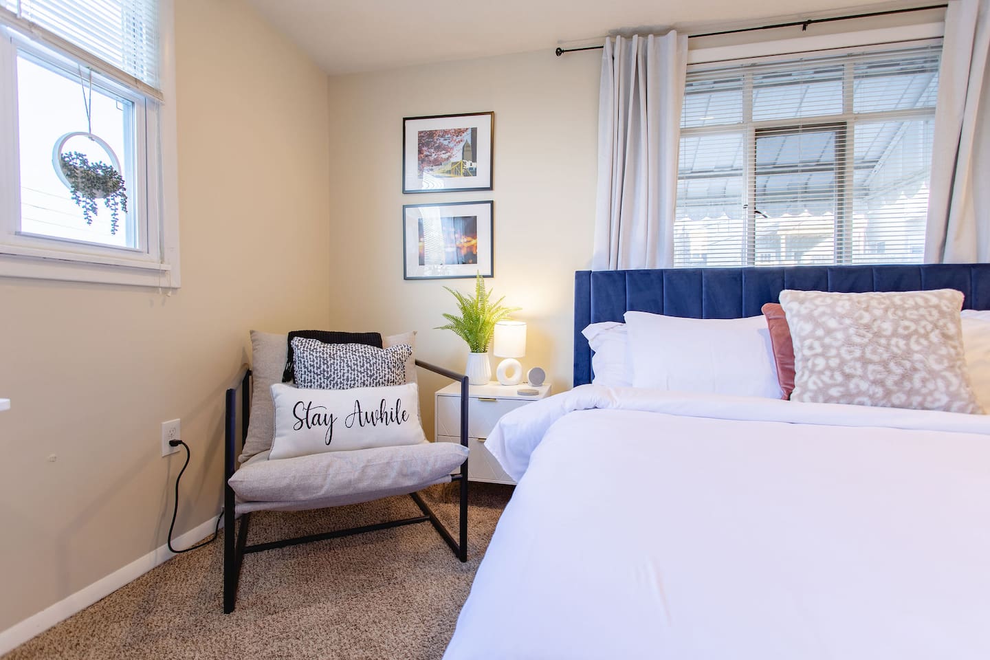 Cozy, spacious room with a queen-sized bed, TV, and a dedicated working space.