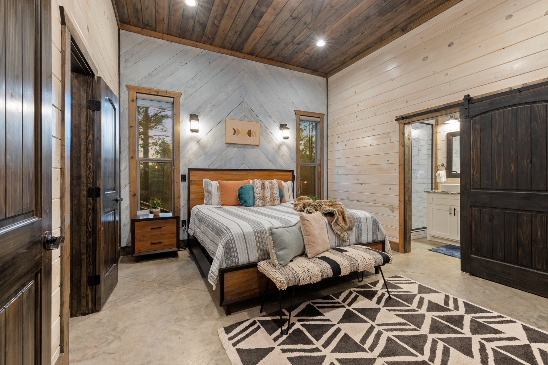 Relax into plush bedding and peaceful forest views for a restful night at Piece of the Moon in this King bedroom ensuite.