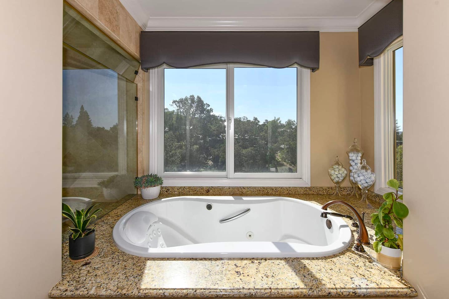 Primary bathroom with jacuzzi and shower.