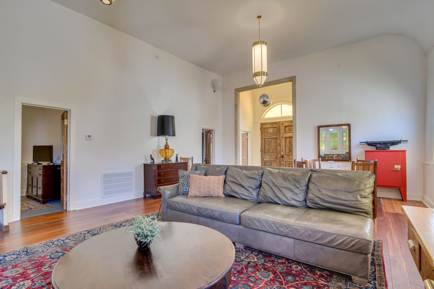 Bright lounge with colorful vintage rug and cozy seating.