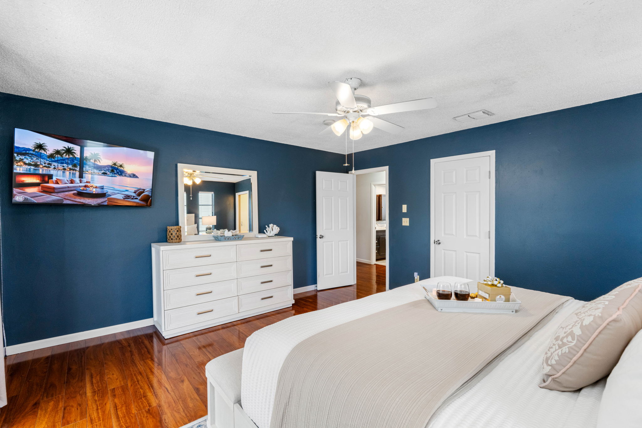 The deep navy accent walls create a rich, moody atmosphere that feels both calming and sophisticated.