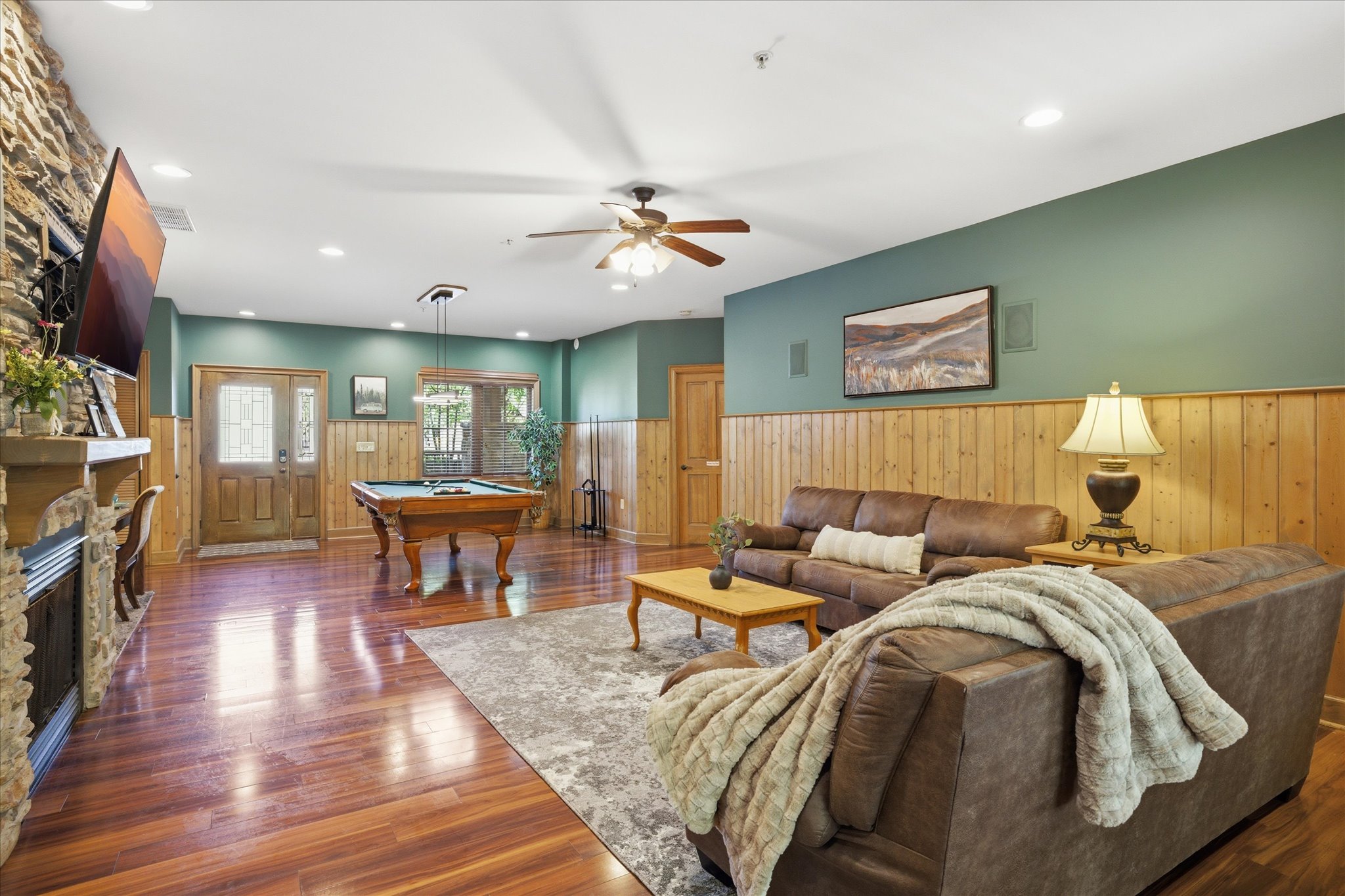 Unwind in unit 312's spacious living room with cozy couches, a gas fireplace, and a large TV for movie nights. Step right out to the back porch to enjoy some fresh air and keep the good vibes going.
