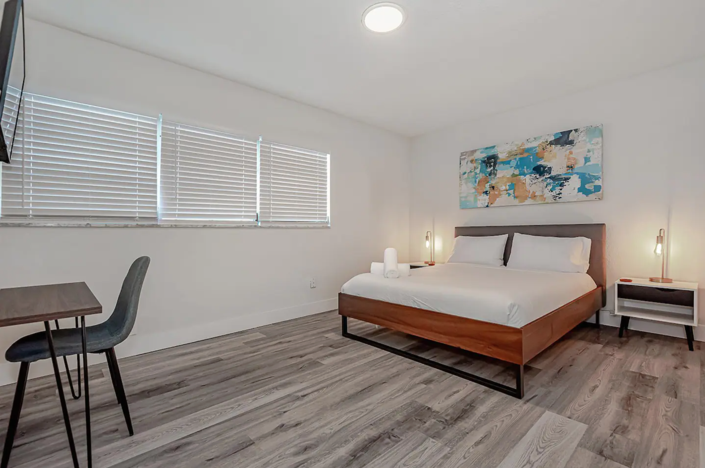 One bedroom with queen bed and dining table