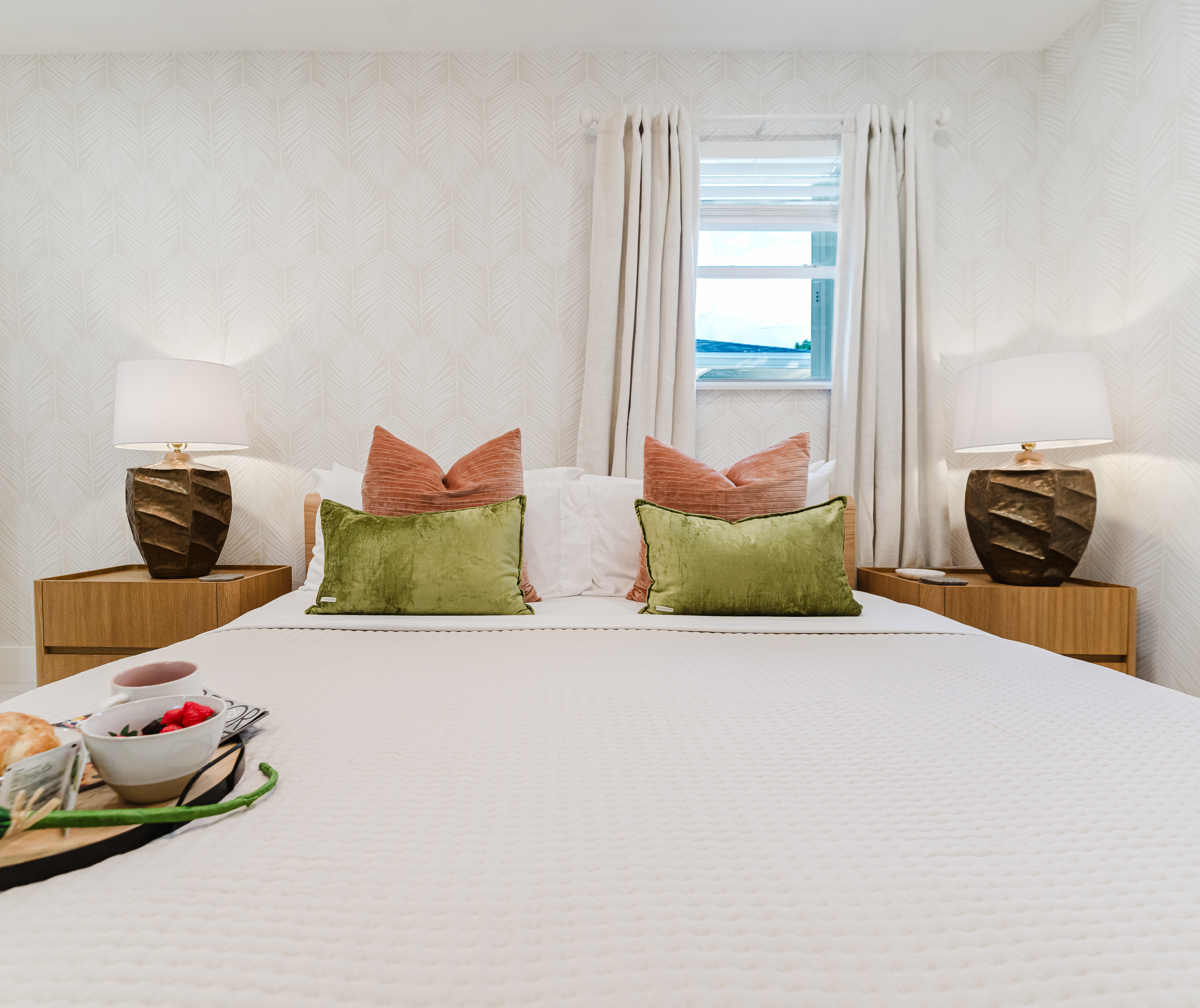 Primary king suite designed for rest and privacy, featuring fresh cotton linens, a Smart TV, and serene Palm Beach–inspired finishes. Includes a walk-in closet and private en-suite bathroom for a comfortable, hotel-style stay.