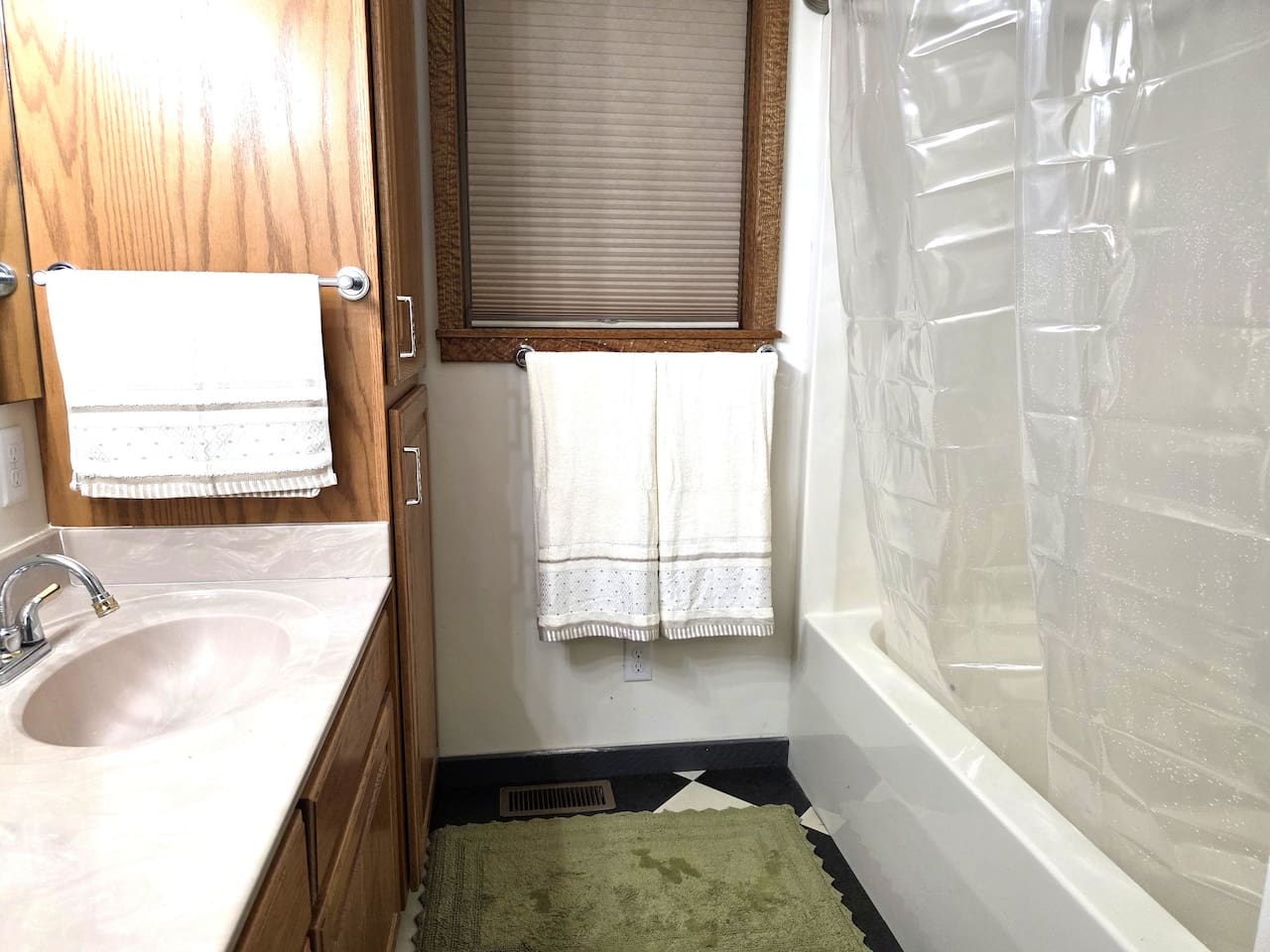 Downstairs bathroom with tub/shower, double sinks and toilet