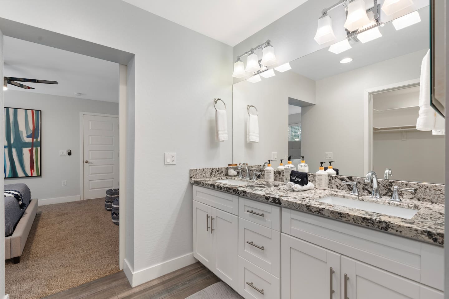 Bright bathroom featuring a large mirror and spacious sink, creating a functional and stylish space.