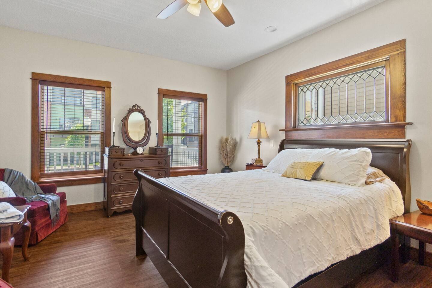 Spacious bedroom with large windows and elegant furniture, creating a bright and sophisticated ambiance.