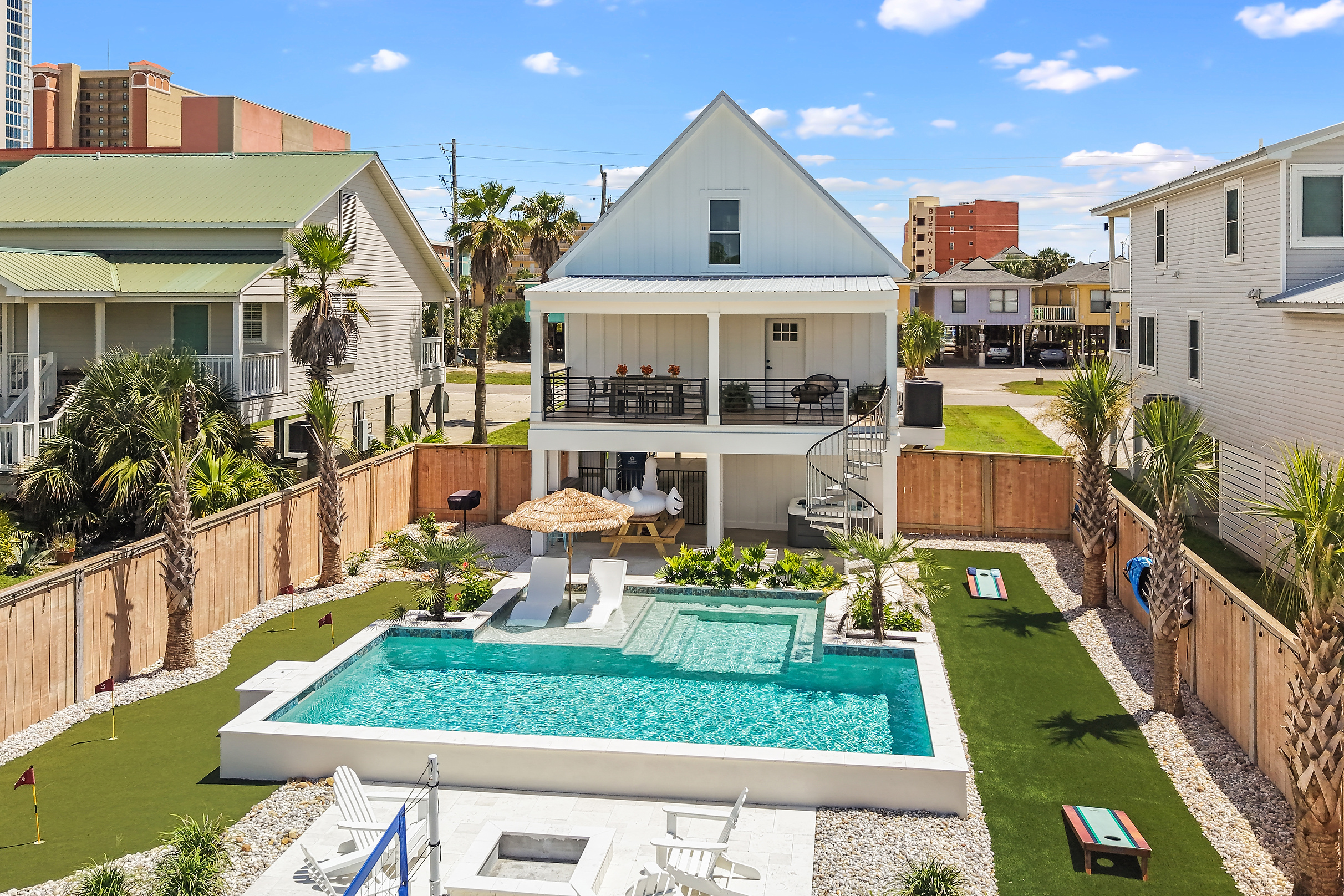 Wide view of the private pool, putting green and backyard fun zone.