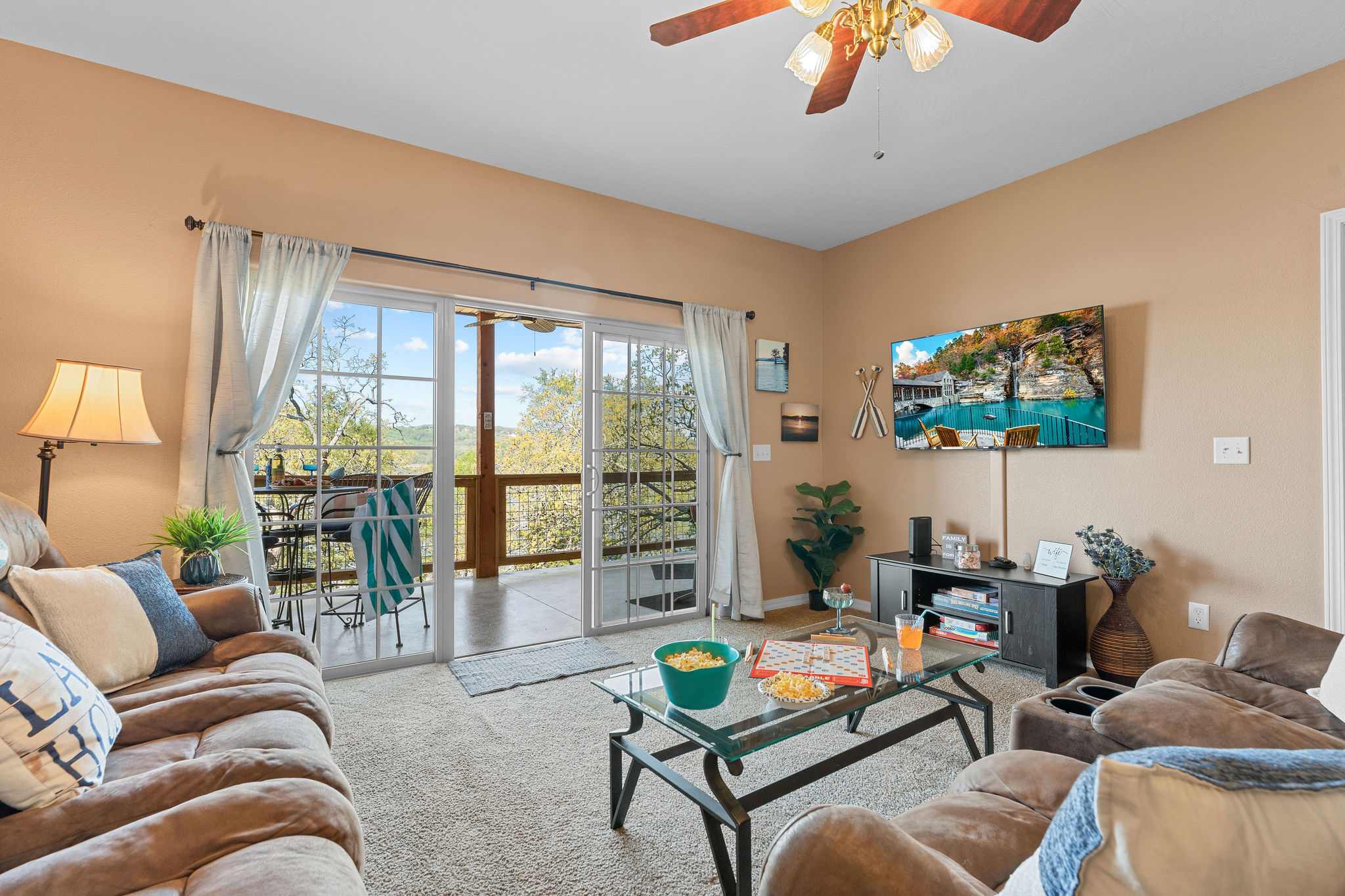A living room witha large screen smart tv and a view!