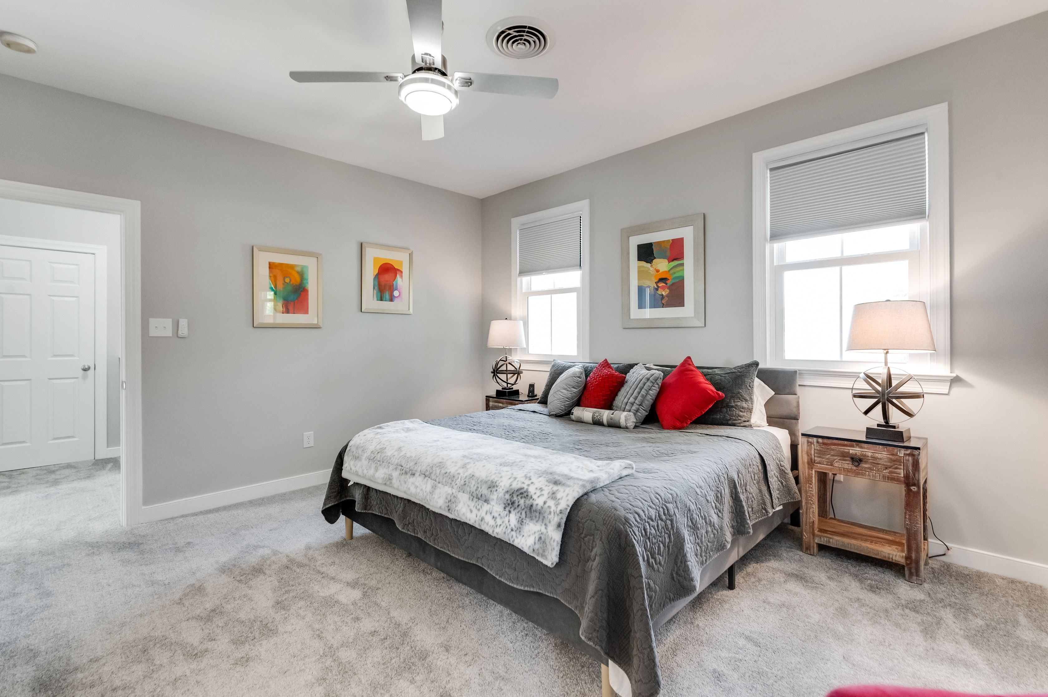 King Bedroom 1: Enjoy colorful artwork and plush bedding in a bright, inviting space!