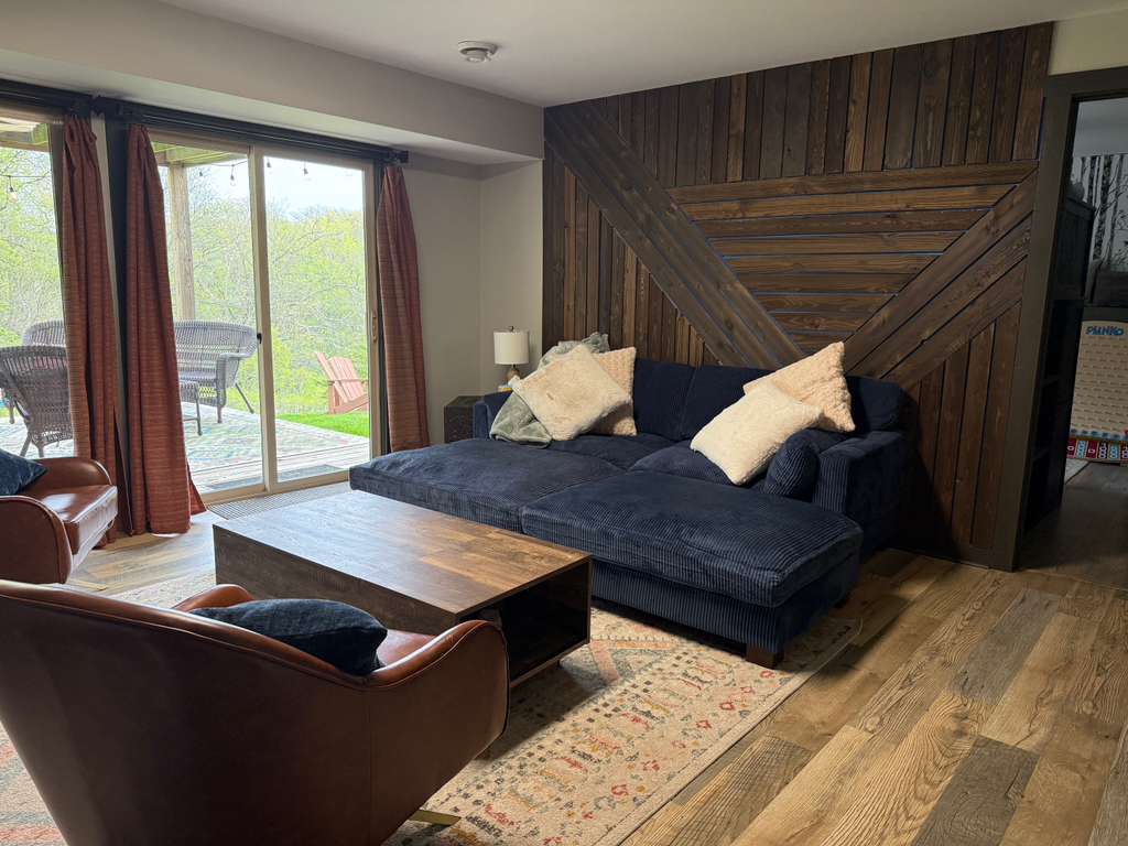 Downstairs living room has big comfy couch.