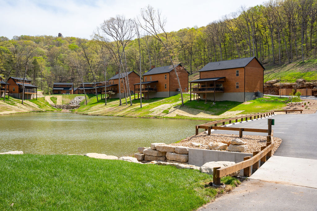 Rolling green grounds link the cabins, pools, and trails across the Tall Timbers Camp community.