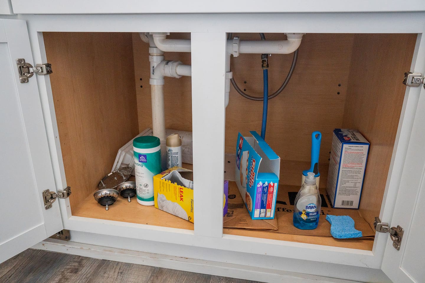 Cleaning materials are conveniently stored in the sink cabinet for easy access during your stay.