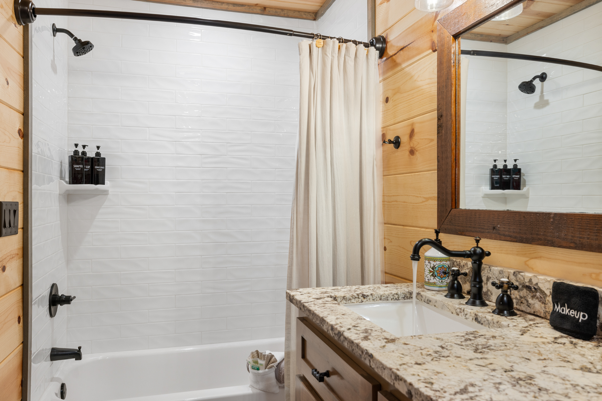 Comfortable guest bathroom with warm wood accents and modern convenience