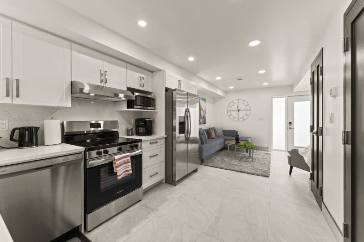 Sleek white cabinetry contrasts beautifully with dark wood floors.