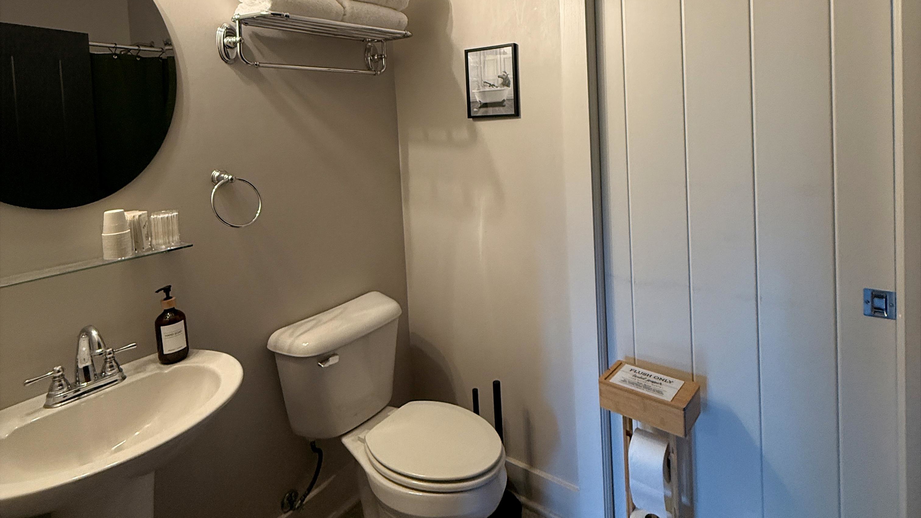 Every retreat needs a pause — this ensuite pairs clean, modern comfort with a touch of bourbon-country humor, reminding guests that even the hardest-working traveler deserves a moment to breathe.