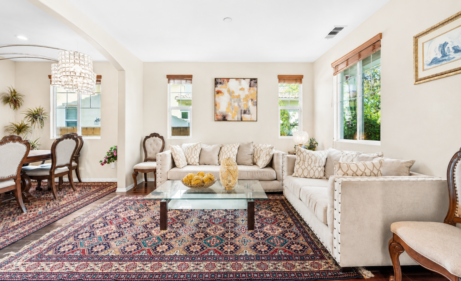 Bright sitting room with soft couches, sunny windows, and a cozy spot to gather.