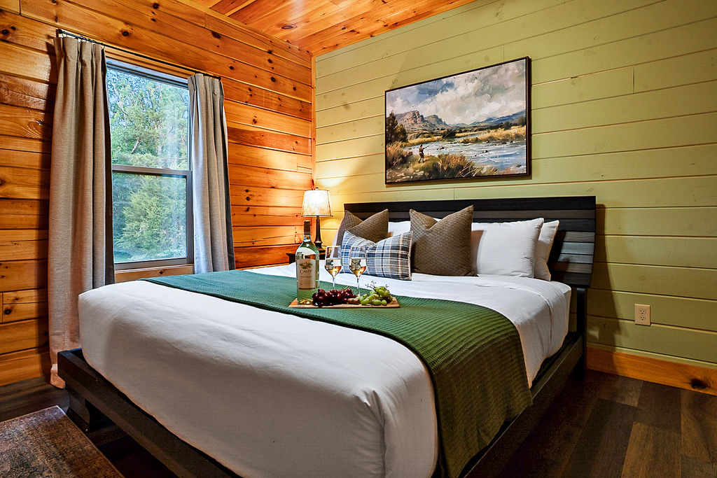 King bedroom with the details curated for comfort- from plush bedding to cozy cabin ambiance