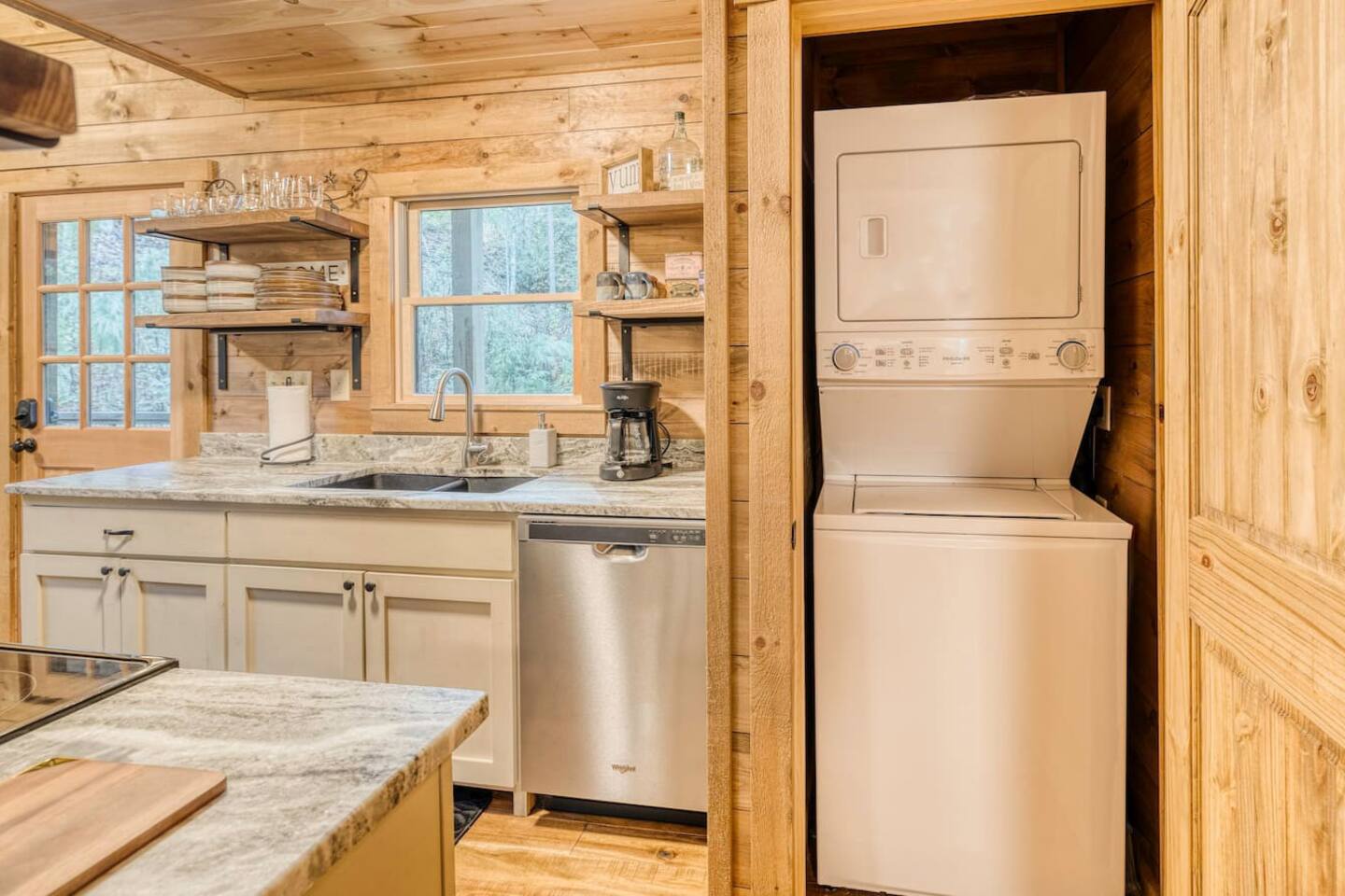 Step into our clean kitchen area, where the rustic ambiance is complemented by modern amenities, offering the perfect blend of convenience and wilderness charm in our cozy cabin retreat.