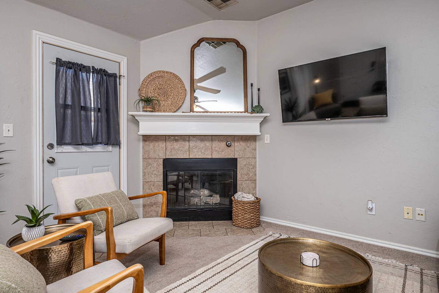 Spacious living area featuring comfortable seating, smart TV, and a warm fireplace.