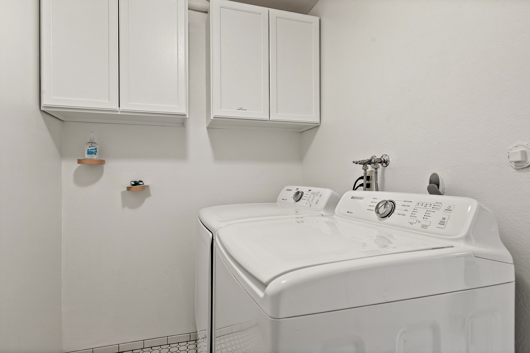 Convenient in-home laundry area with washer, dryer, and storage—everything you need for longer stays.