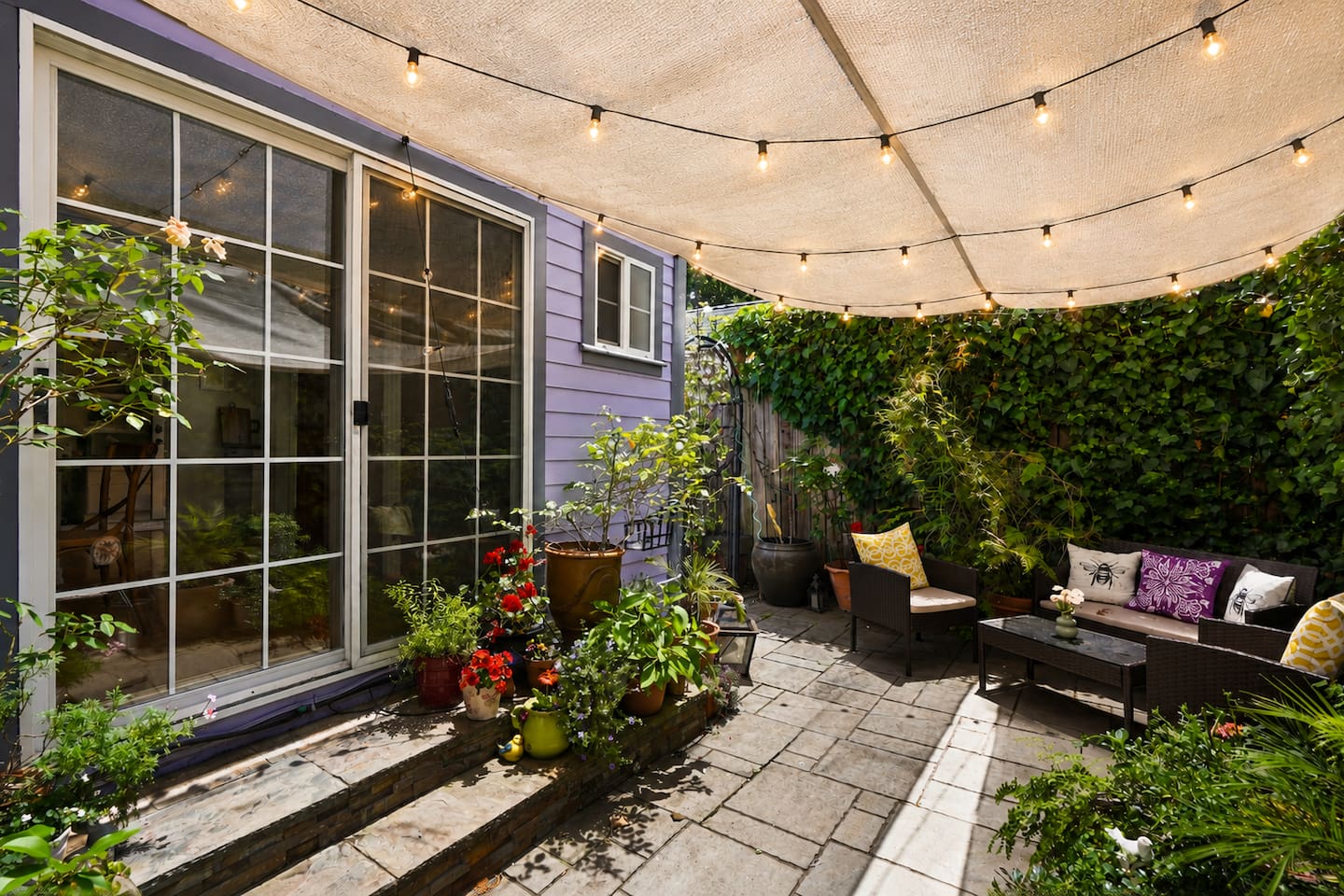 Small but cozy backyard filled with flowers — a quiet spot to unwind after wine tasting or exploring downtown Napa.