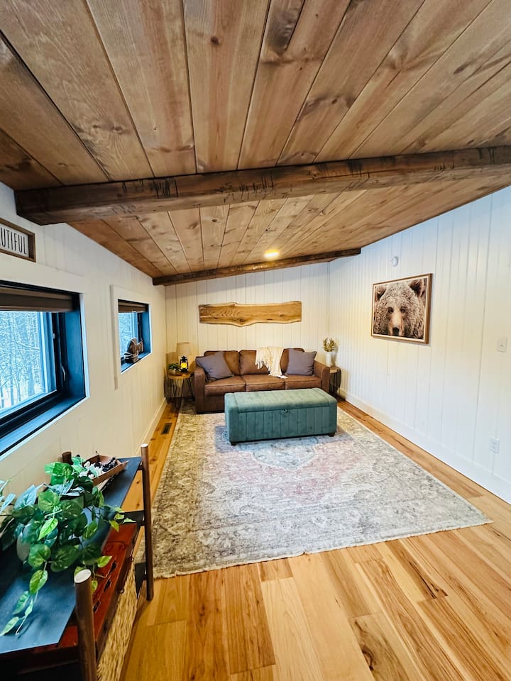 This cozy, open loft features a comfortable queen pullout sofa bed, perfect for two people. The loft overlooks the living room, offering a unique blend of privacy and openness, ideal for those who enjoy a spacious and airy living environment.