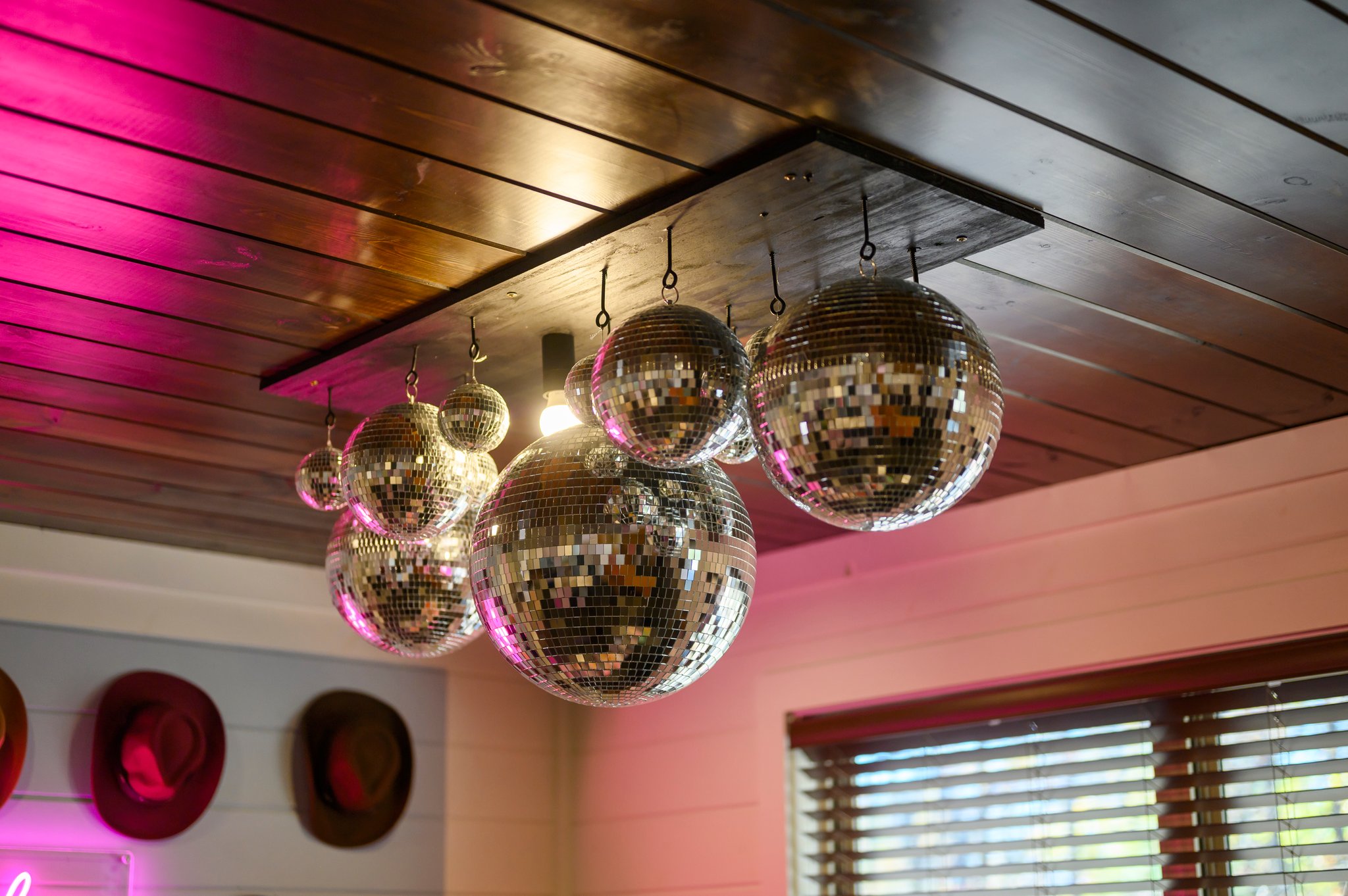 Handmade and one-of-a-kind, our custom disco ball chandelier adds sparkle to the dining area!