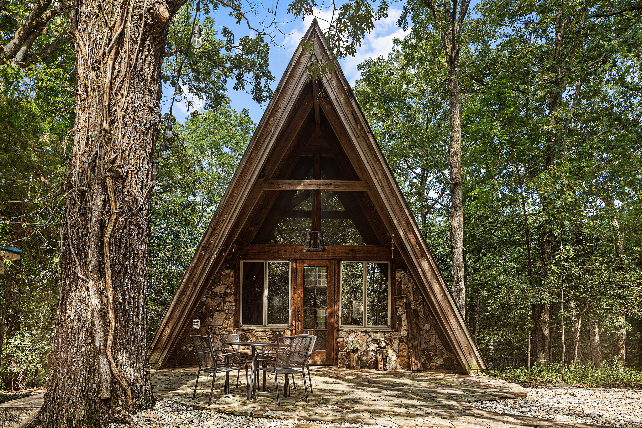 Charming stone-front A-frame with patio dining.
