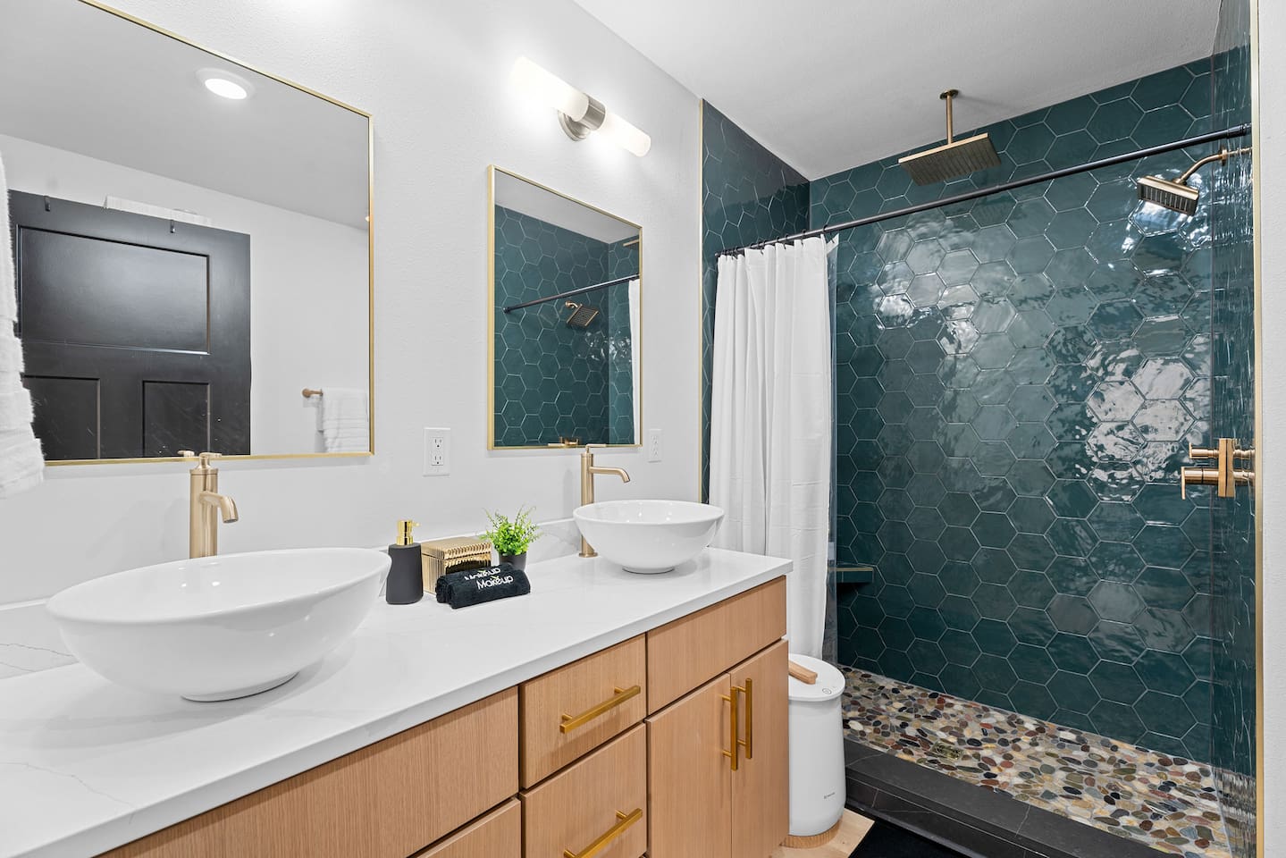 Sleek Bathroom Oasis: Experience luxury with stylish fixtures and emerald tile accents! Step out of the luxury shower and wrap yourself in a warm towel from the provided towel warmer!
