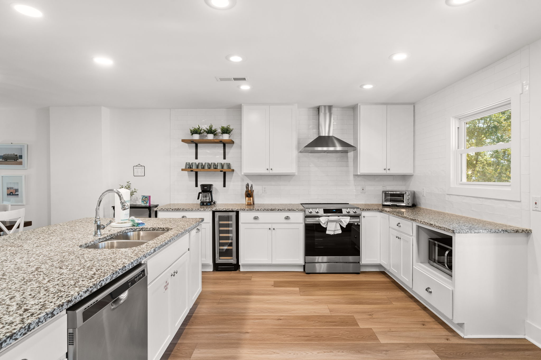 Side B: Fully equipped kitchen featuring ample counter and storage space, and wine fridge.