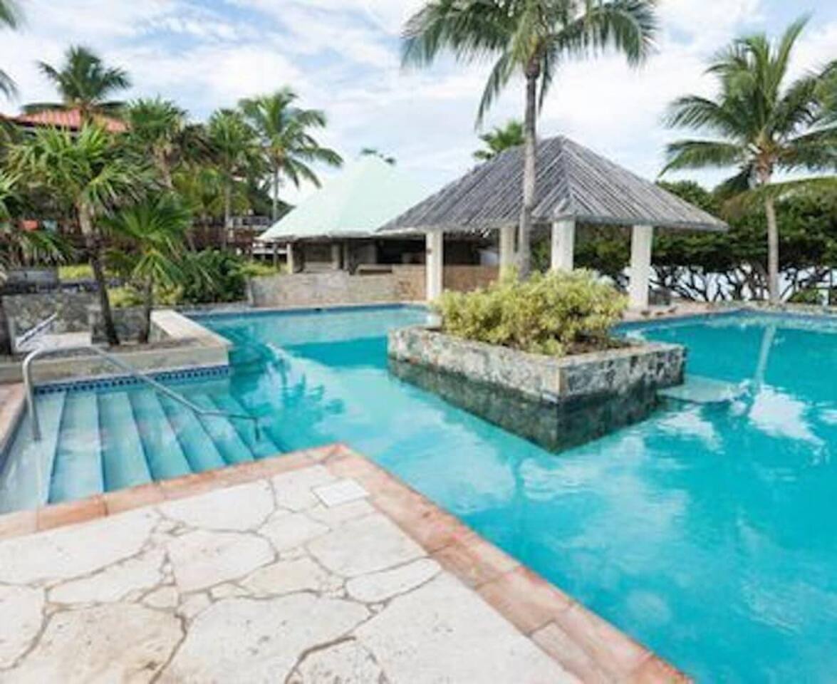 Inviting pool surrounded by lush gardens and tropical charm.