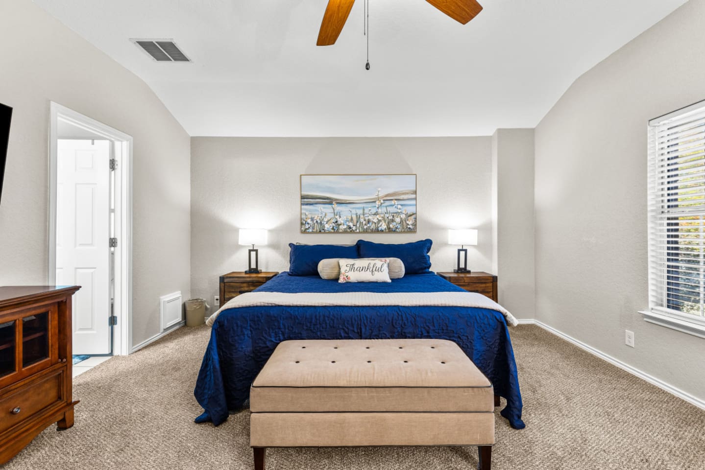 Spacious primary bedroom with king bed, reading area, blackout blinds, luxury linens, and a Smart TV with streaming to help you recharge in total comfort.
